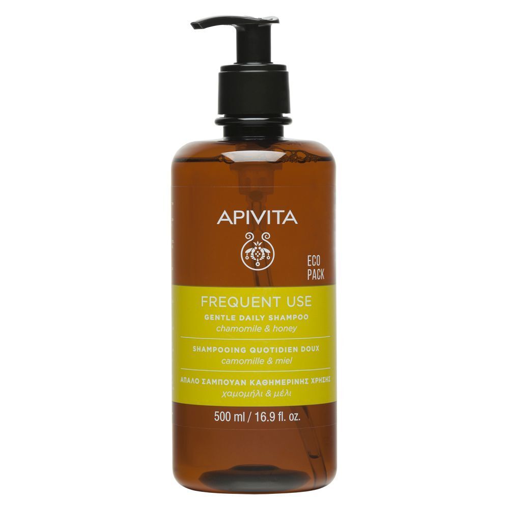 Flacon marron, pompe noire. Étiquette jaune. Marque : Apivita. Shampooing.