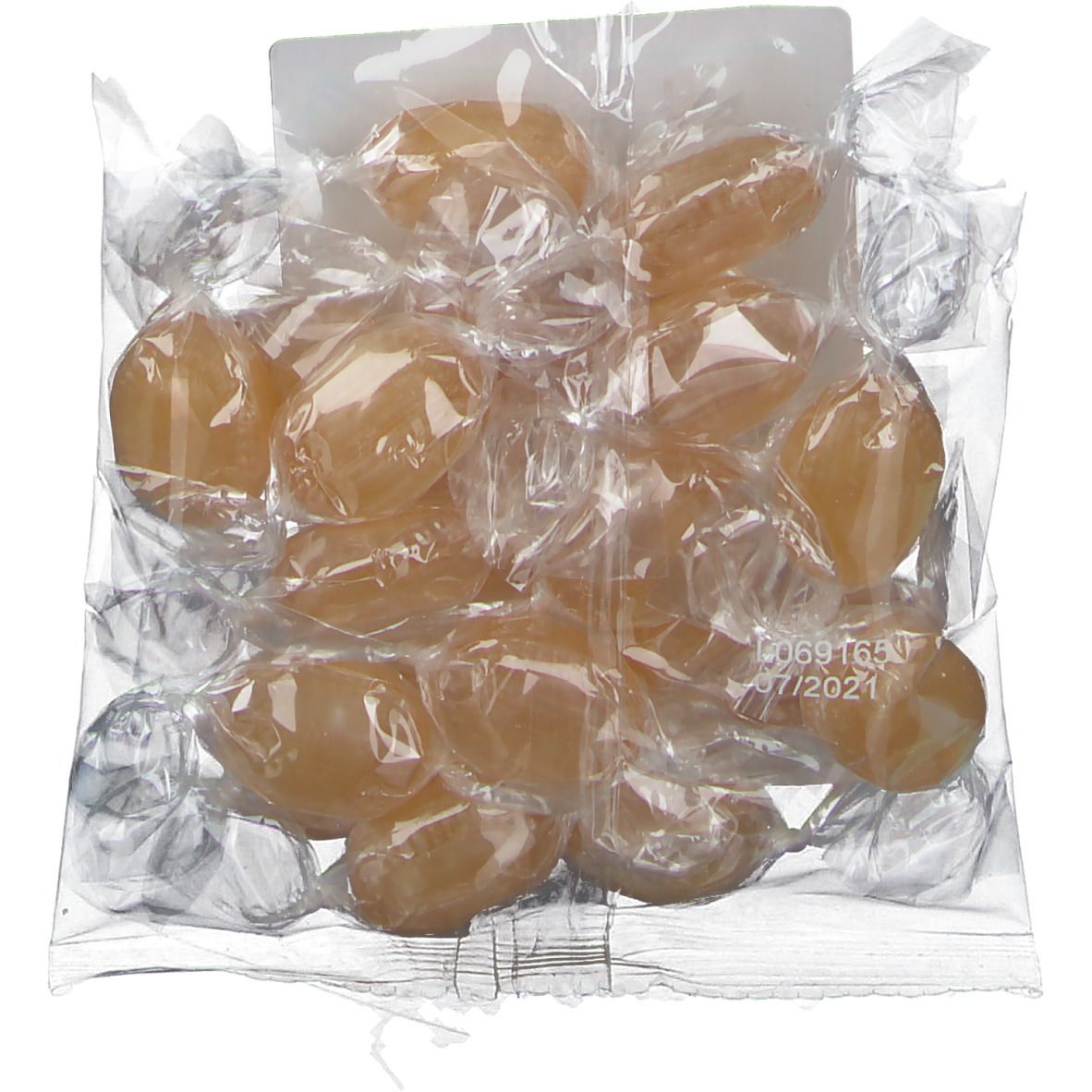 Bonbons emballés individuellement dans un film transparent. Date de péremption visible.