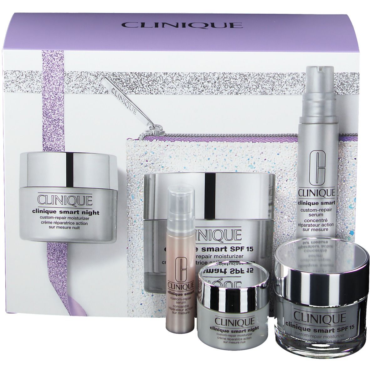 Coffret cadeau avec plusieurs produits cosmétiques, dont crèmes, sérums et trousse de maquillage. Emballage avec des accents argentés.