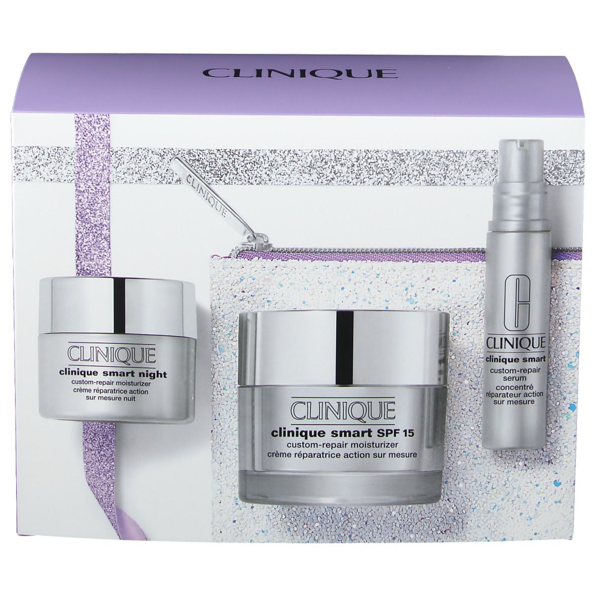 Coffret cadeau avec des produits cosmétiques, dont crèmes et sérum. Emballage avec des accents argentés et violets.