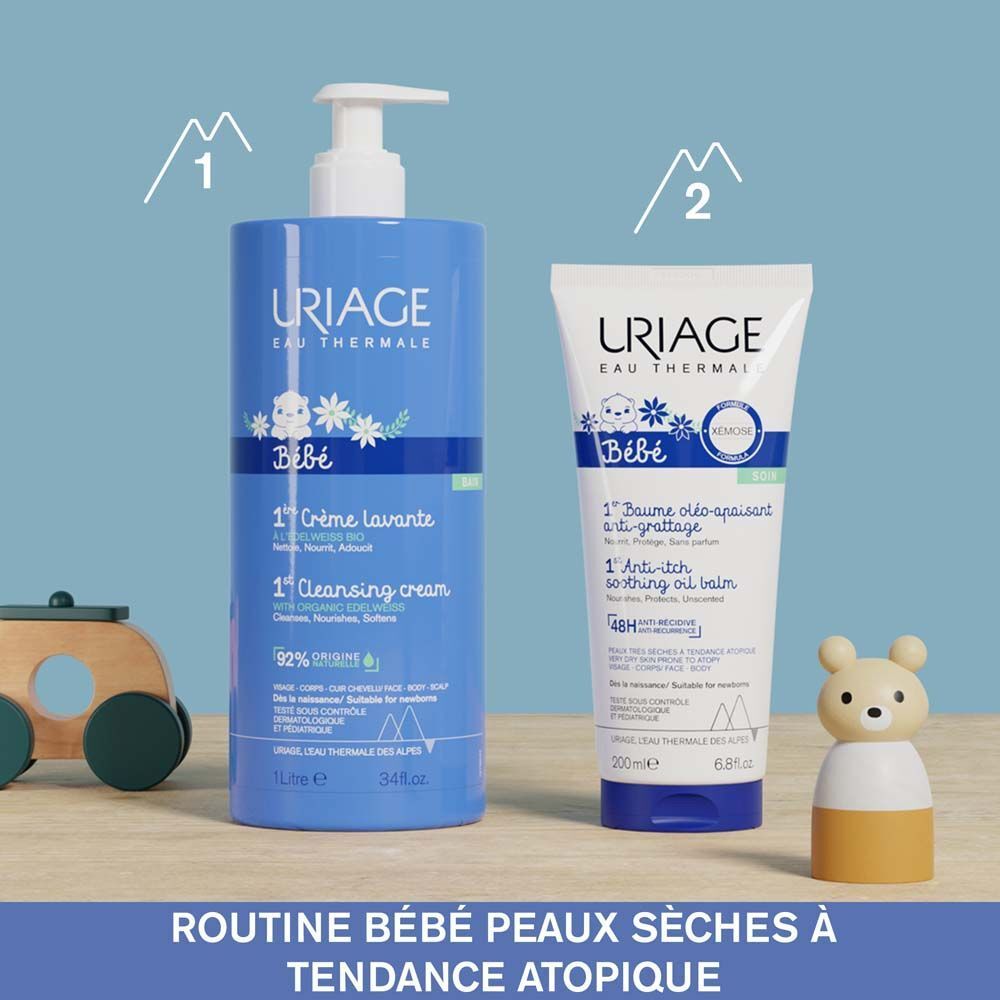 Tube de Baume oléo-apaisant Uriage Bébé Xémose avec produit appliqué. 200ml. Bouchon bleu.