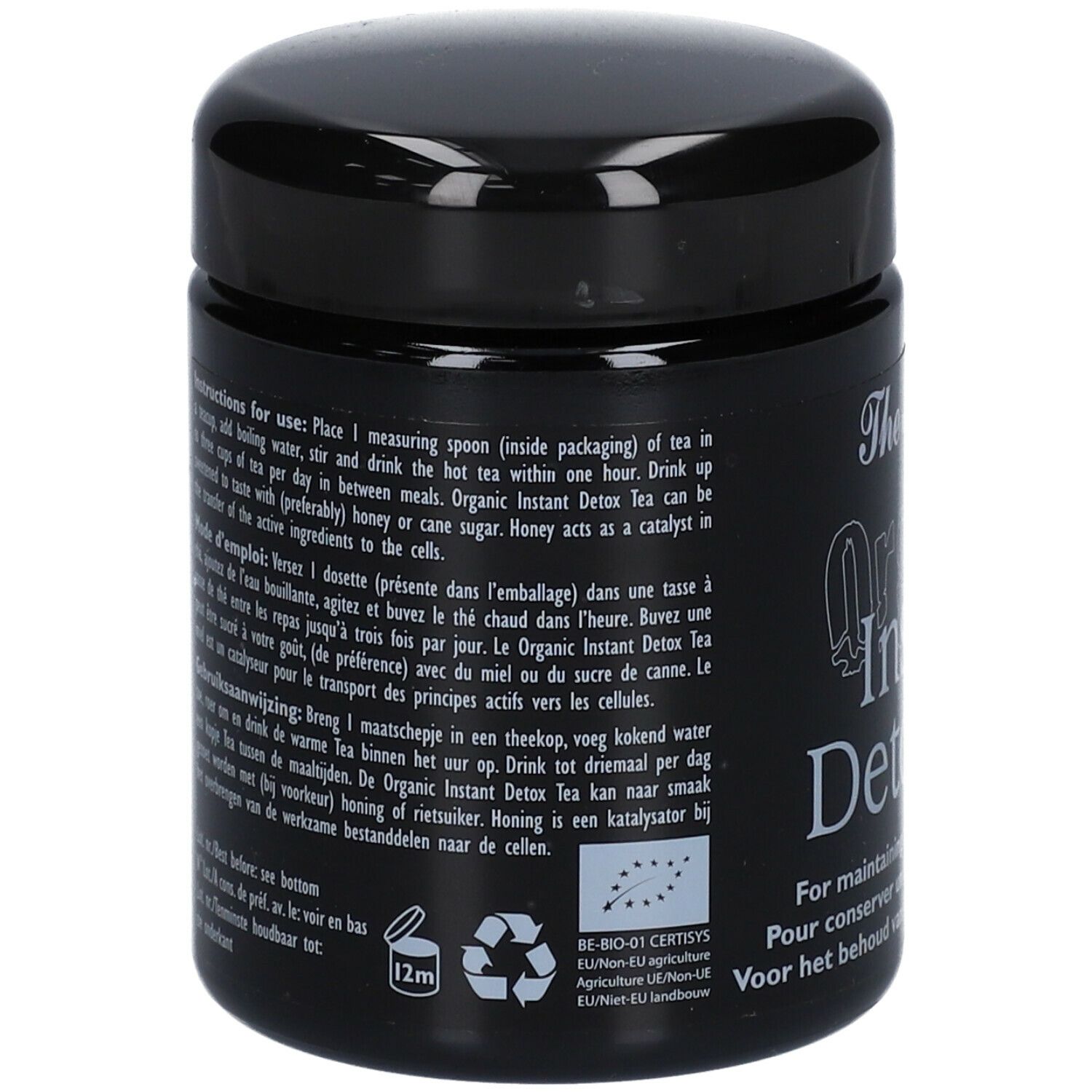 Schwarzes Glas mit Deckel. Text in mehreren Sprachen, darunter Anweisungen zur Verwendung des Produkts.