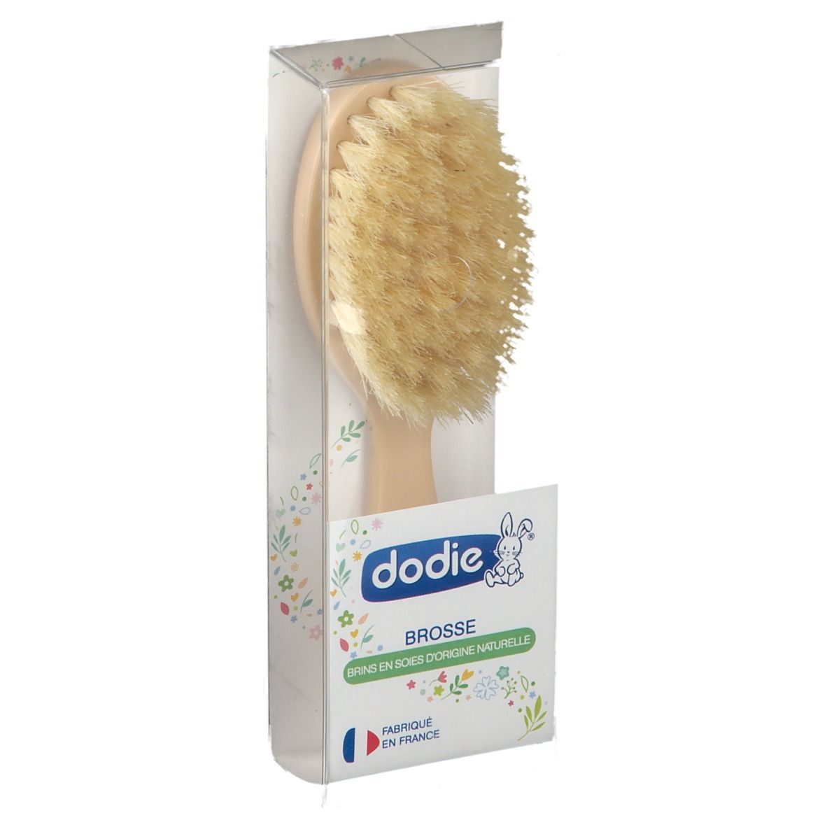 Brosse à cheveux avec manche clair et poils, en emballage. Marque Dodie. Fabriqué en France.