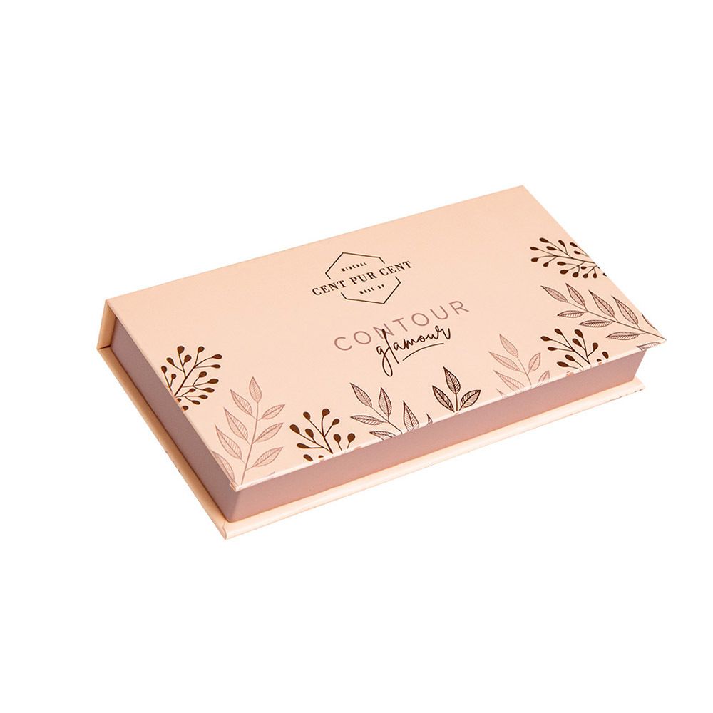 Gesloten cosmetica palet. Roze-goudkleurig met bloemmotief en belettering.