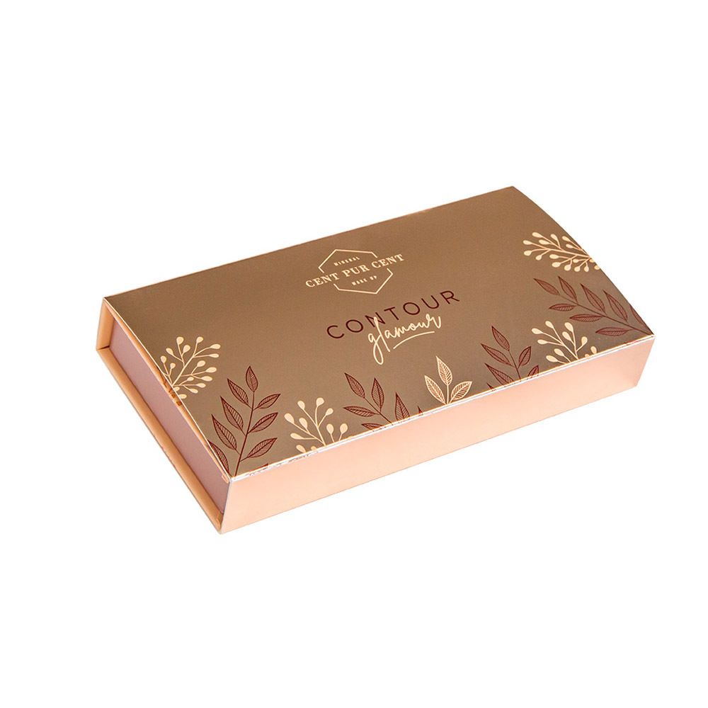 Palette cosmétique fermée. Doré avec motif floral et lettrage.