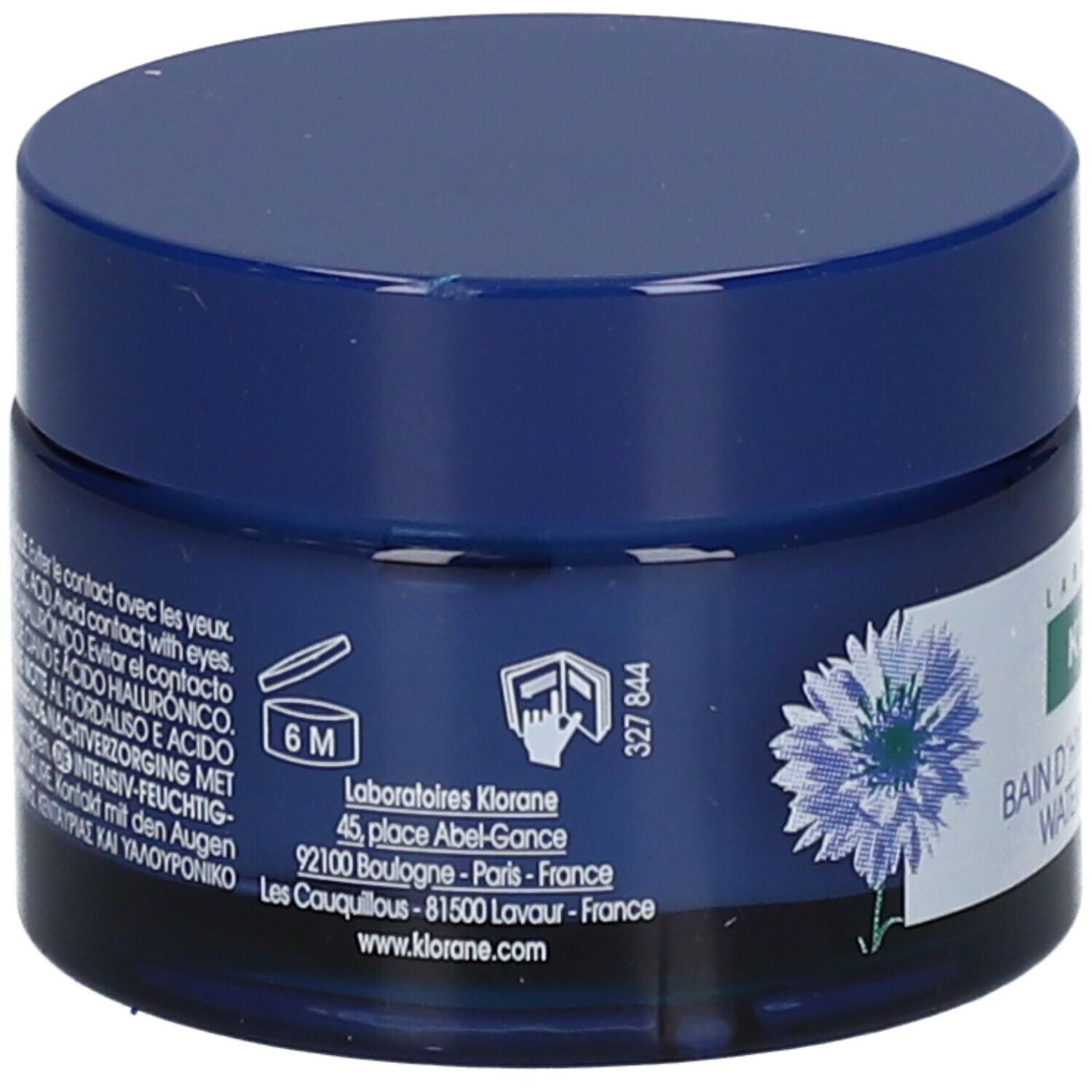 Dos du pot bleu. Inscription: KLORANE, Bain d'Hydratation Nuit Water Sleeping Mask. Motif de bleuet. Texte.