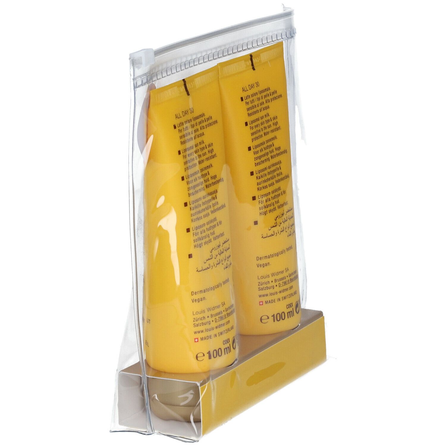 Schuin geplaatste transparante zak met twee gele tubes. Op elke staat "100 ml". Achterkant met tekst.