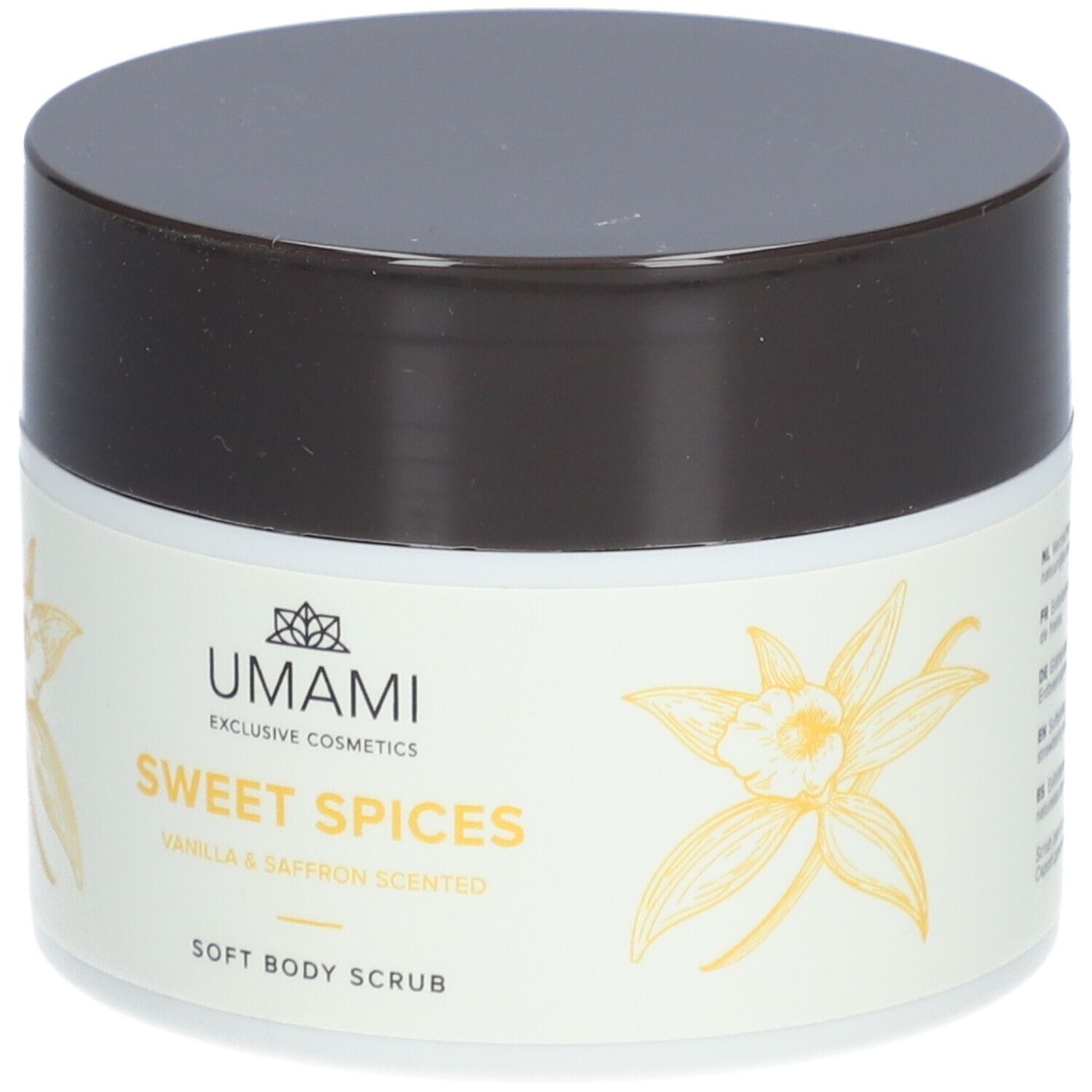 Weißes Tiegel mit braunem Deckel. Aufschrift: UMAMI, Sweet Spices, Vanilla & Saffron Scented, Soft Body Scrub. Gelbe Blüten.