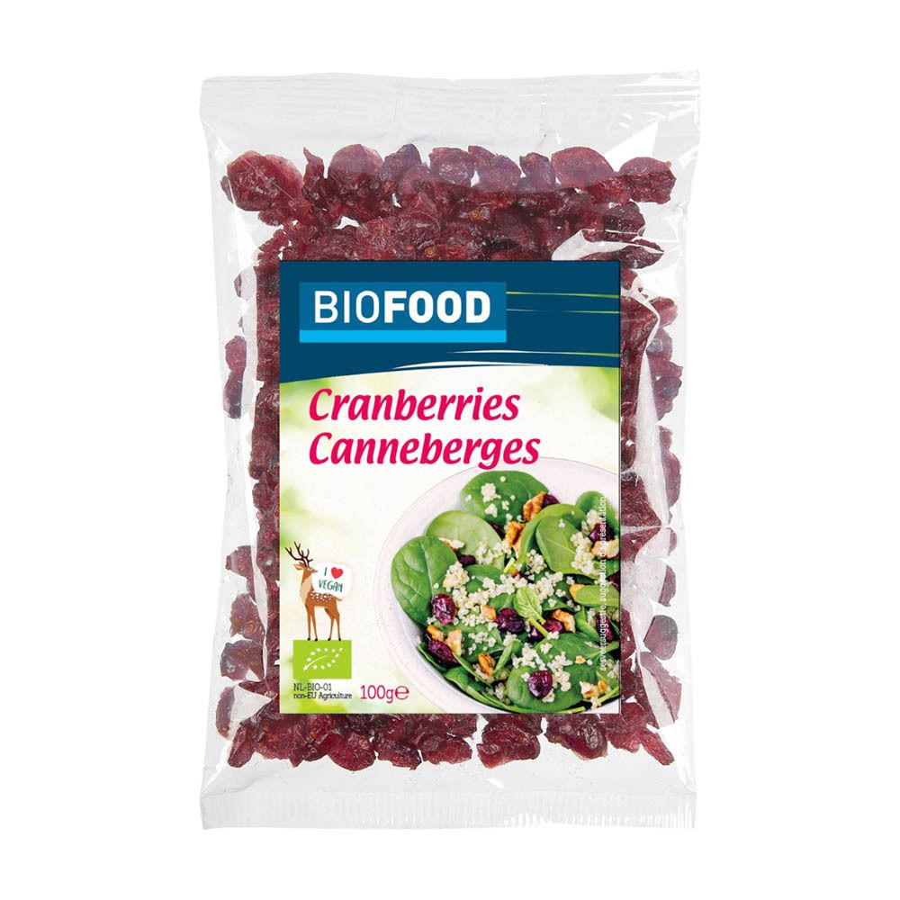 Klare Tüte mit BIOFOOD Cranberries. Rote Cranberries und ein Bild von Salat. Etikett mit Produktnamen und Vegan-Logo.
