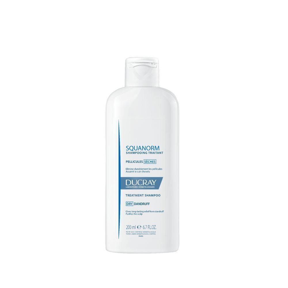 Witte shampoo fles. Opschrift: SQUANORM, PELLICULES SÈCHES, DUCRAY. 200 ml.