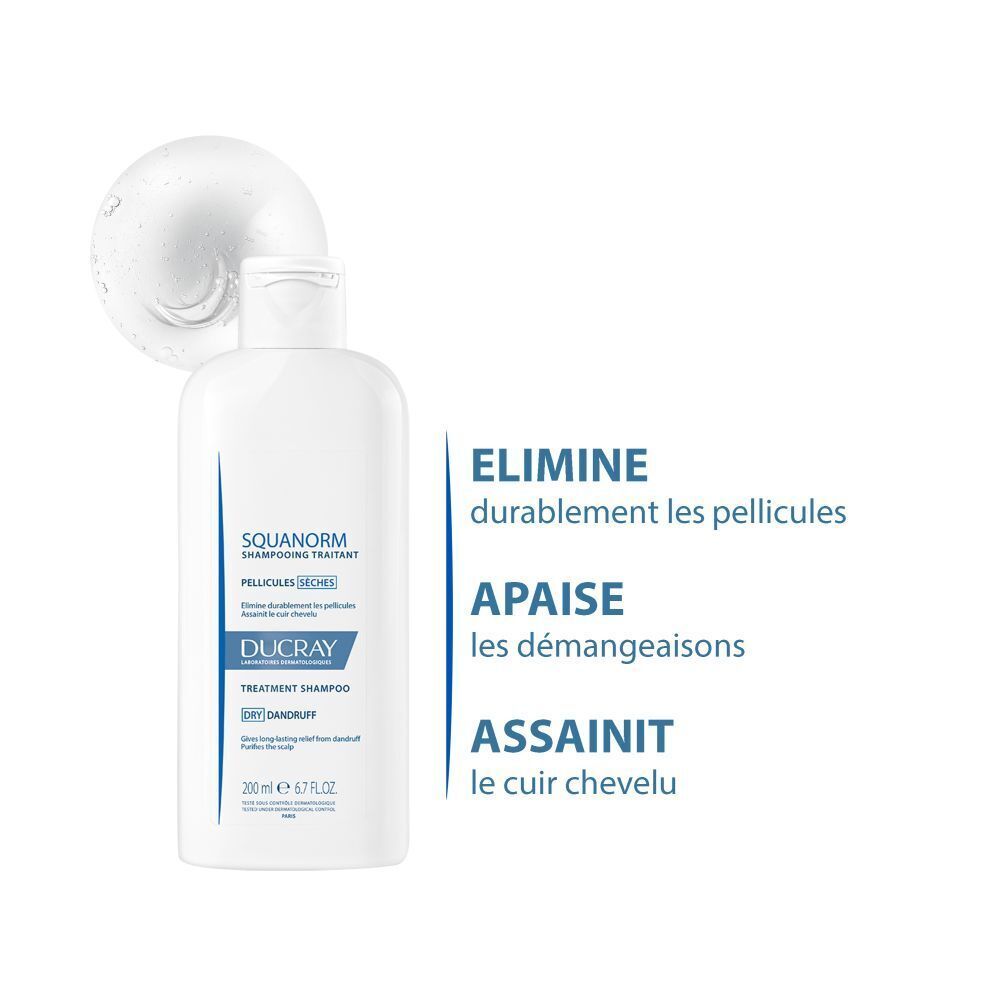 Flacon de shampooing avec mousse. Inscriptions: SQUANORM, PELLICULES SÈCHES, DUCRAY. 200 ml.