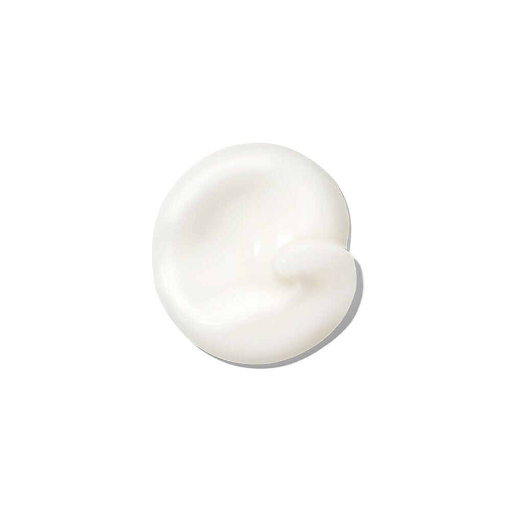 Kleurvlek crème op witte achtergrond. Ronde vorm met lichte draai.