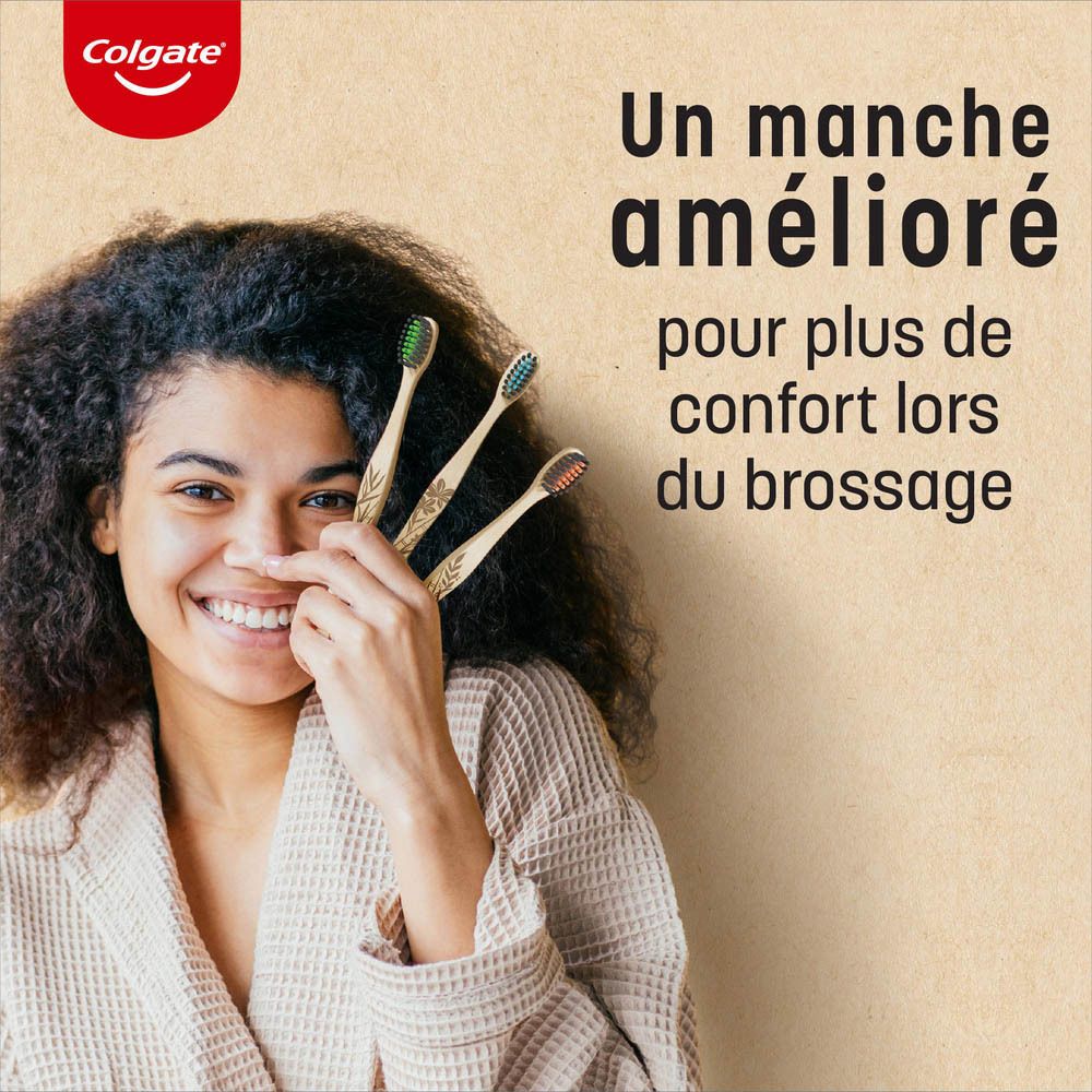 Deux brosses à dents Colgate en bambou dans un gobelet. Soies vertes et bleues, manche en bambou. Texte: pointe fine.