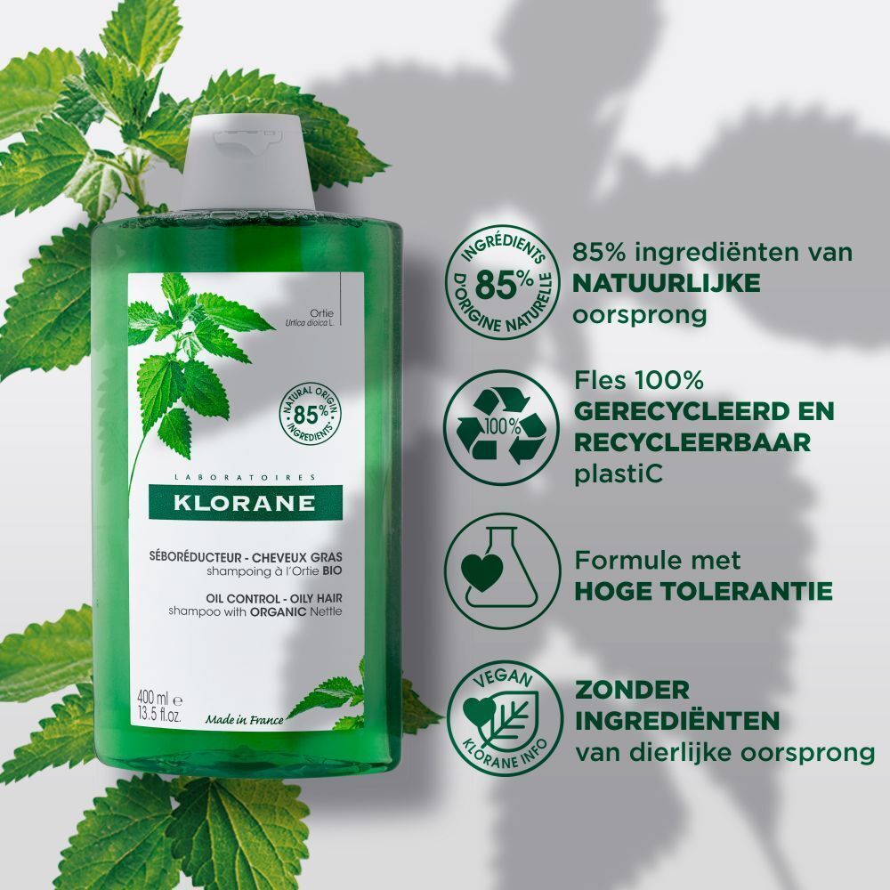 Klorane shampoo fles. Tekst: 85% natuurlijke ingrediënten. Vermindert talg. Kleine lettertjes.