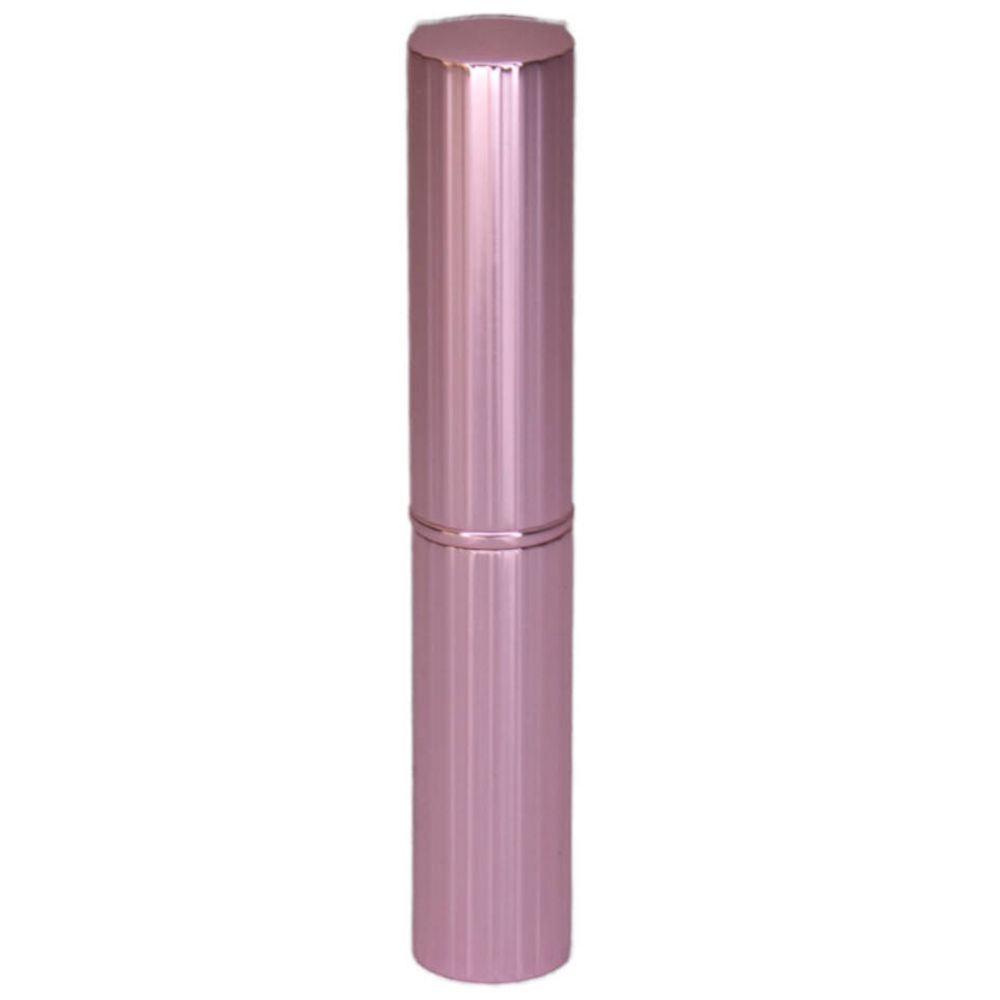 Stick de correcteur rose cylindrique. Surface cannelée, bouchon cylindrique.