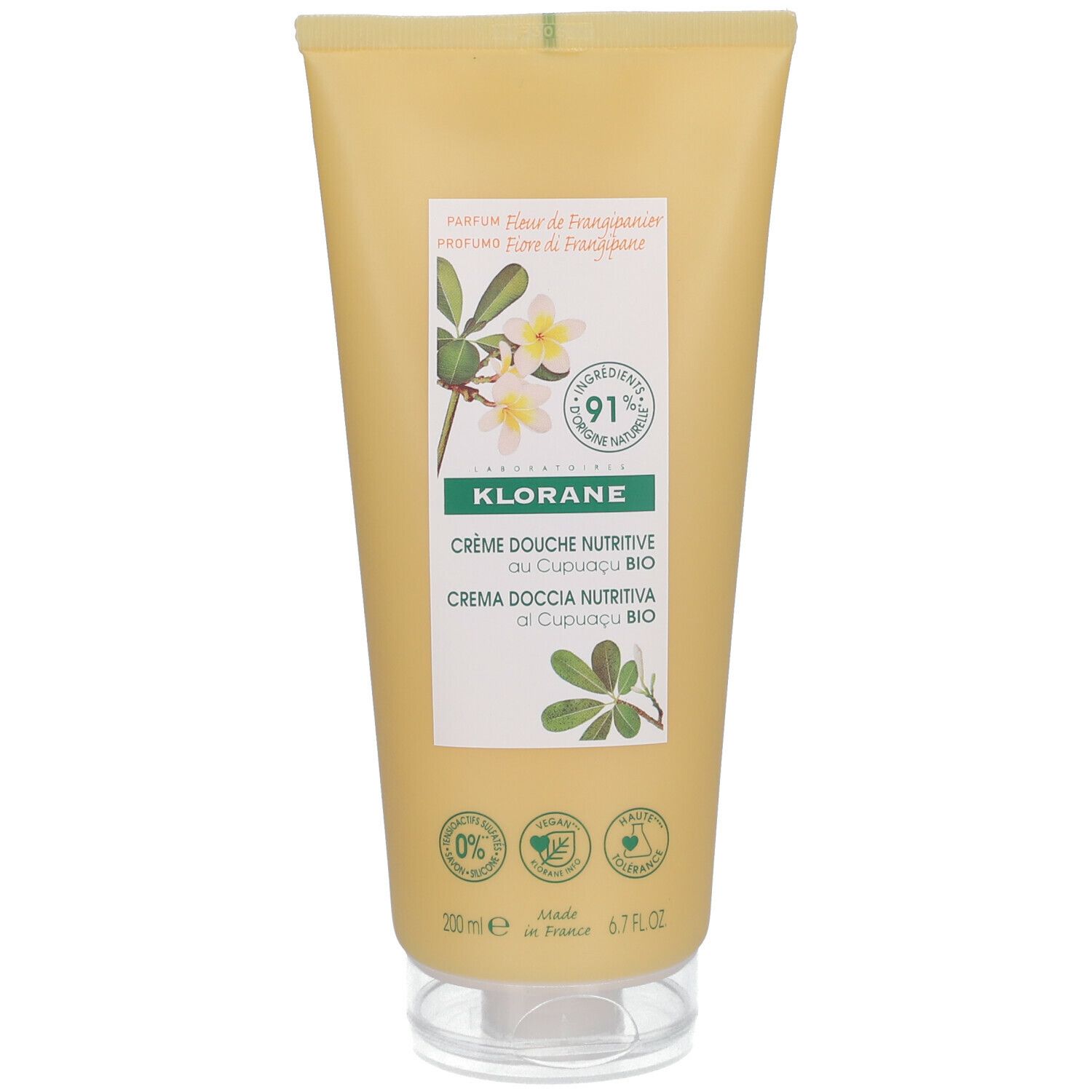 Tube de crème de douche KLORANE jaune avec fleurs de frangipanier. Face avant avec nom du produit, ingrédients et certifications.