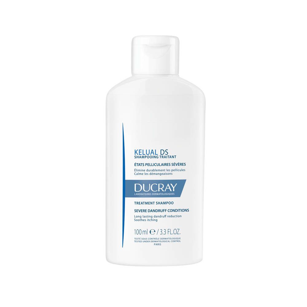 Flacon de shampooing blanc. Inscription: KELUAL DS, DUCRAY. Texte: Shampooing traitant, états pelliculaires sévères, 100 ml.