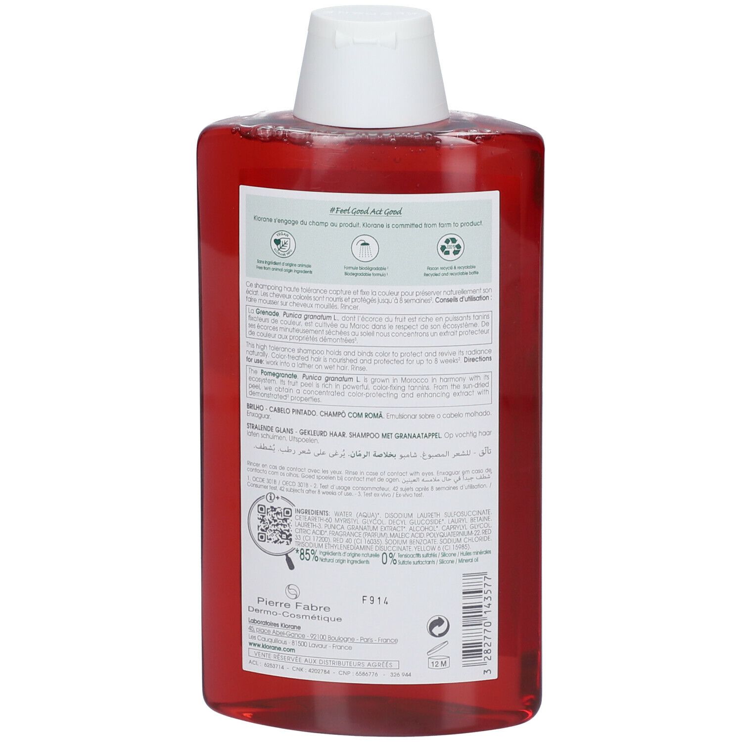 Klorane granaatappel shampoo. Achterkant van de rode fles met witte dop. Tekst en informatie op het etiket.