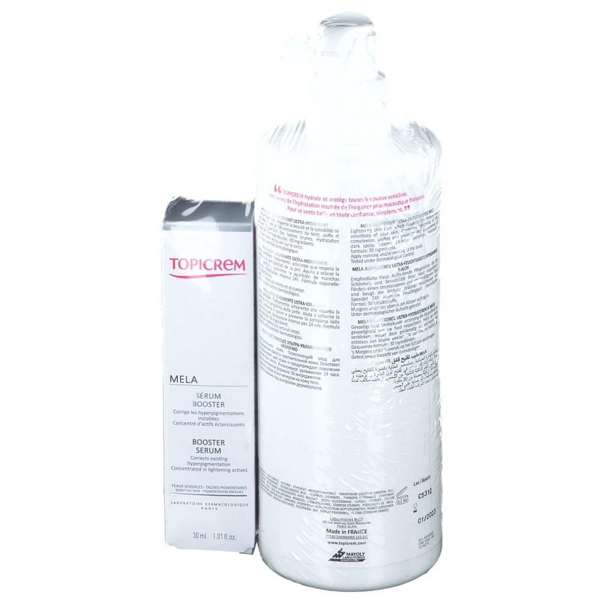 TOPICREM MELA serum en bodylotion. Achterkant van serum en fles met tekst. Verpakt in folie.