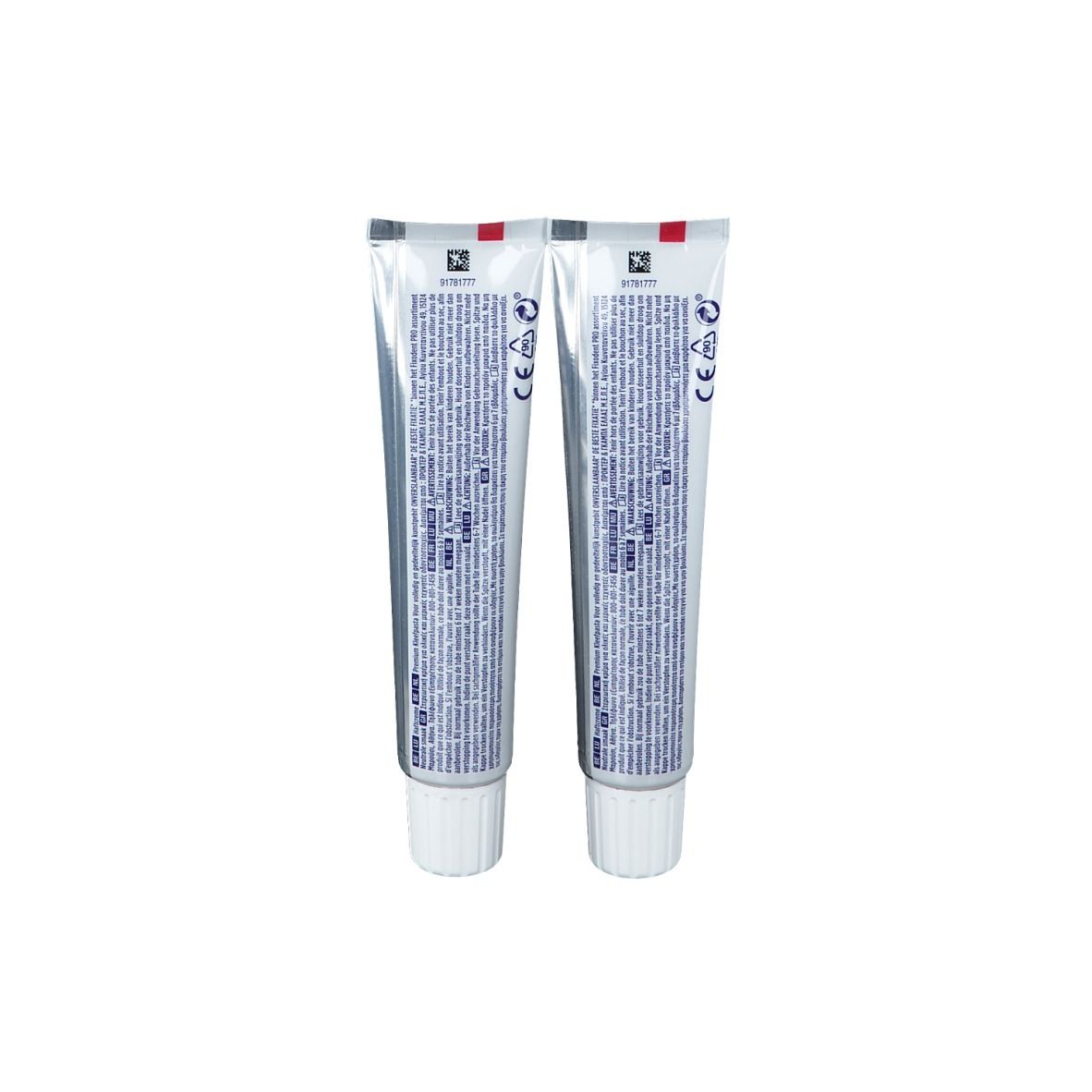 Achterkant van twee tubes Fixodent Pro Plus kleefcrème. Zilveren tubes met tekst en logo's. Witte schroefdoppen.