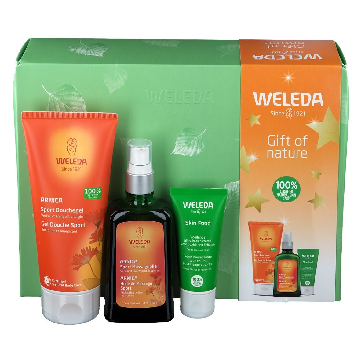 Cadeauset met douchegel, massageolie en crème. Producten in groene en oranje verpakkingen. Merk: Weleda.