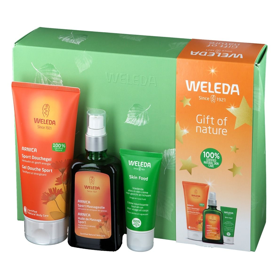 Cadeauset met douchegel, massageolie en crème. Producten in groene en oranje verpakkingen. Merk: Weleda.