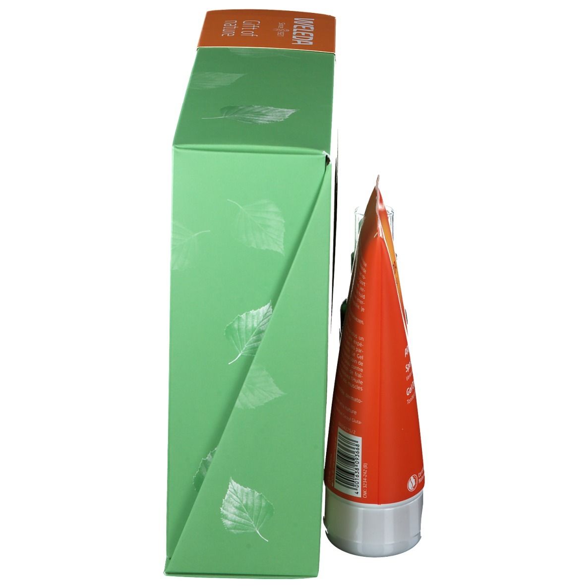 Zijaanzicht van de geschenkverpakking. Groene doos met bladerpatroon. Oranje tube zichtbaar.