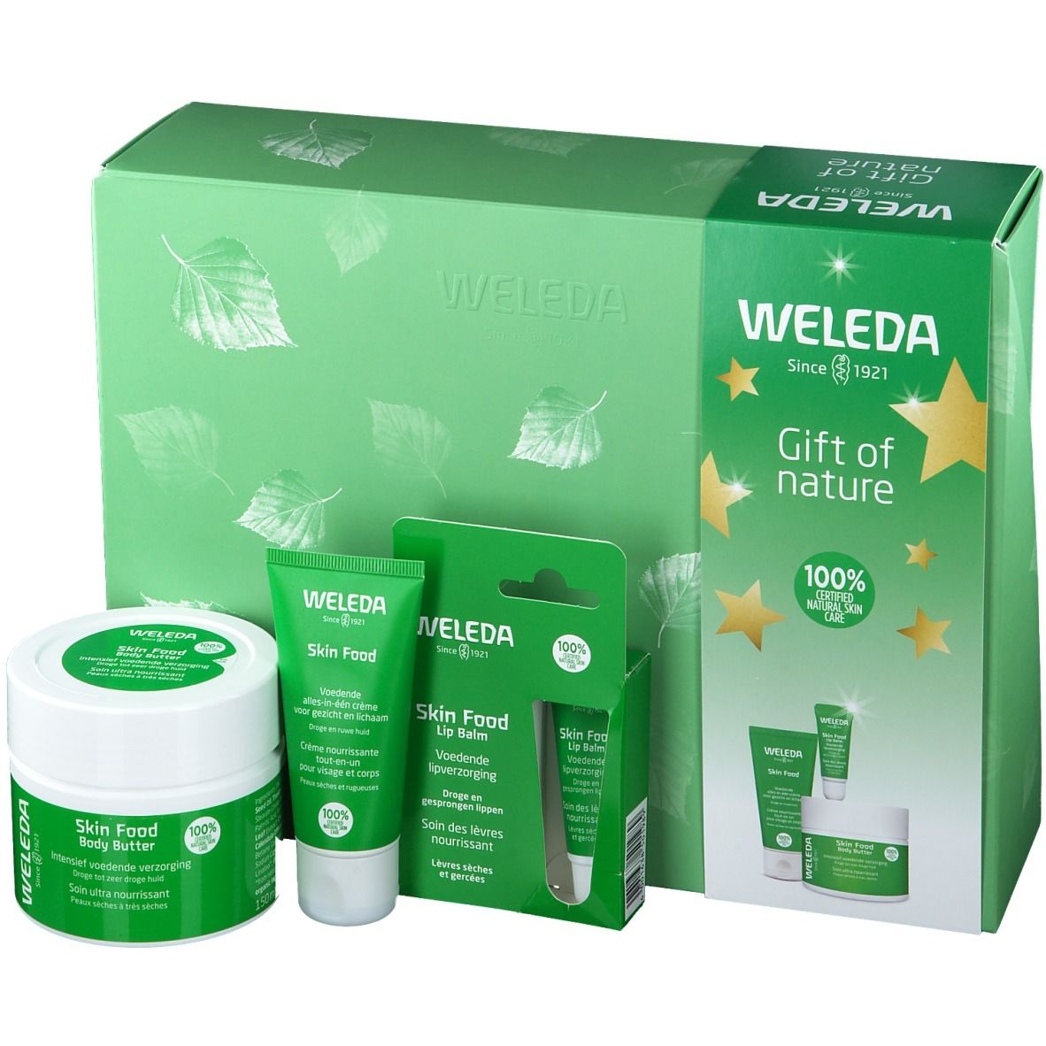 Cadeauset met lotion, crème en lippenbalsem. Groene verpakking. Weleda-logo en sterren.
