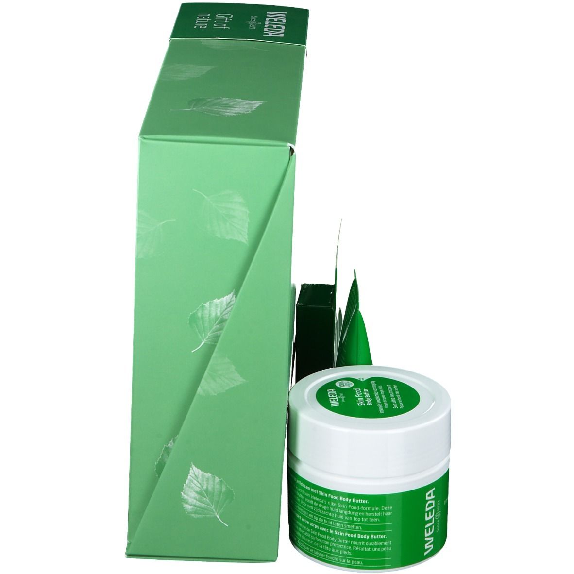 Groene geschenkdoos met producten. Zijaanzicht. Weleda-logo en bladeren.
