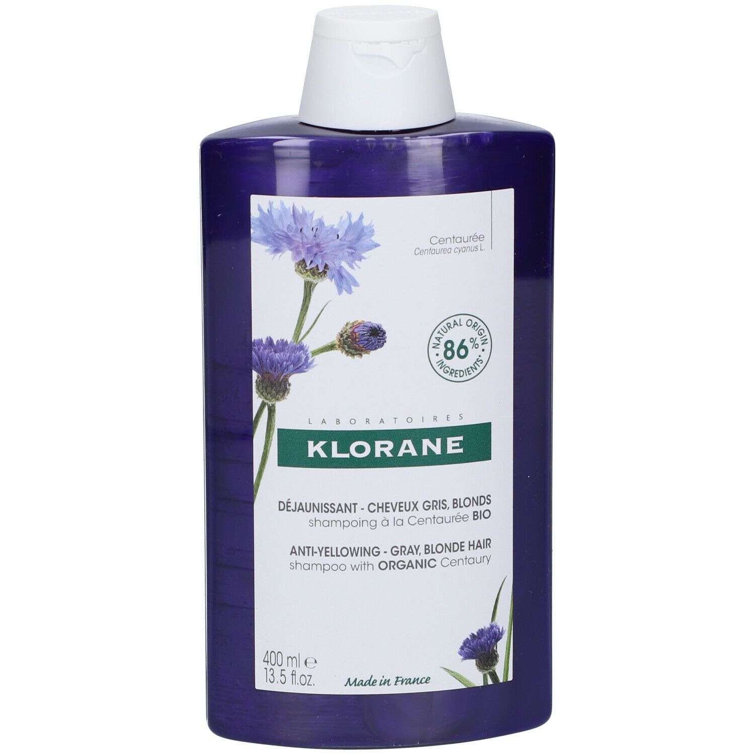 Fles Klorane shampoo. Paarse vloeistof, witte dop. Etiket met korenbloem illustratie, tekst: Anti-geel shampoo.