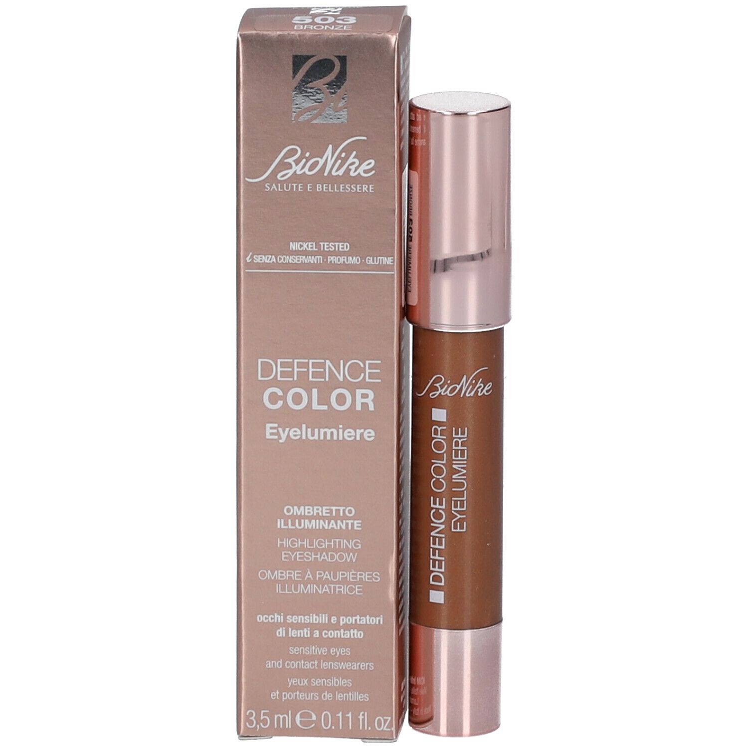 Eyelumiere-stift en verpakking. Verpakking: roségoud, tekst: DEFENCE COLOR Eyelumiere, Ombretto Illuminante.