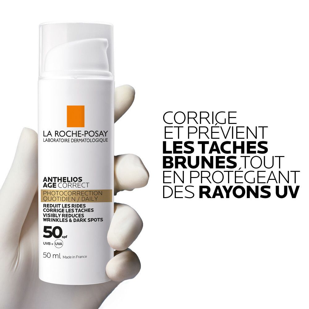 La Roche-Posay Anthelios Age-Correct Crème de Jour Légère SPF50. Tube blanc, texte, main gantée.