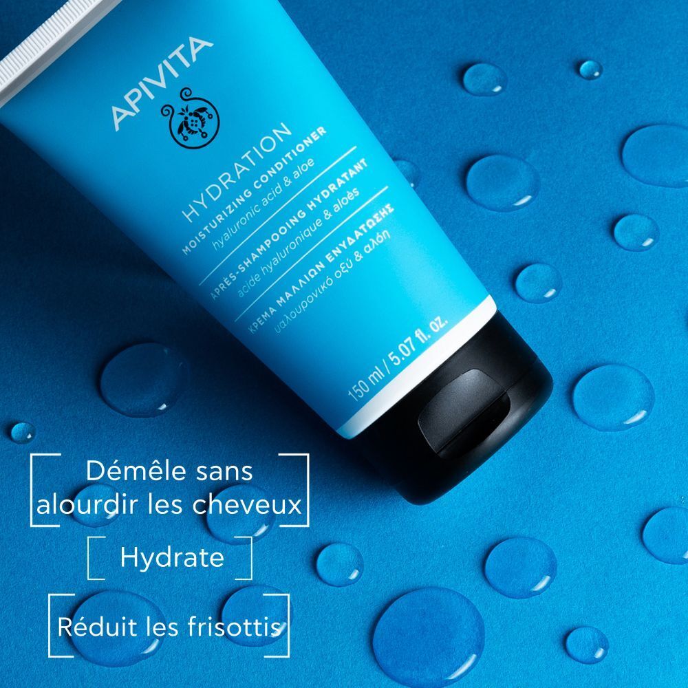 Tube bleu. Texte: Démêle, hydrate, réduit les frisottis. Gouttes d'eau.