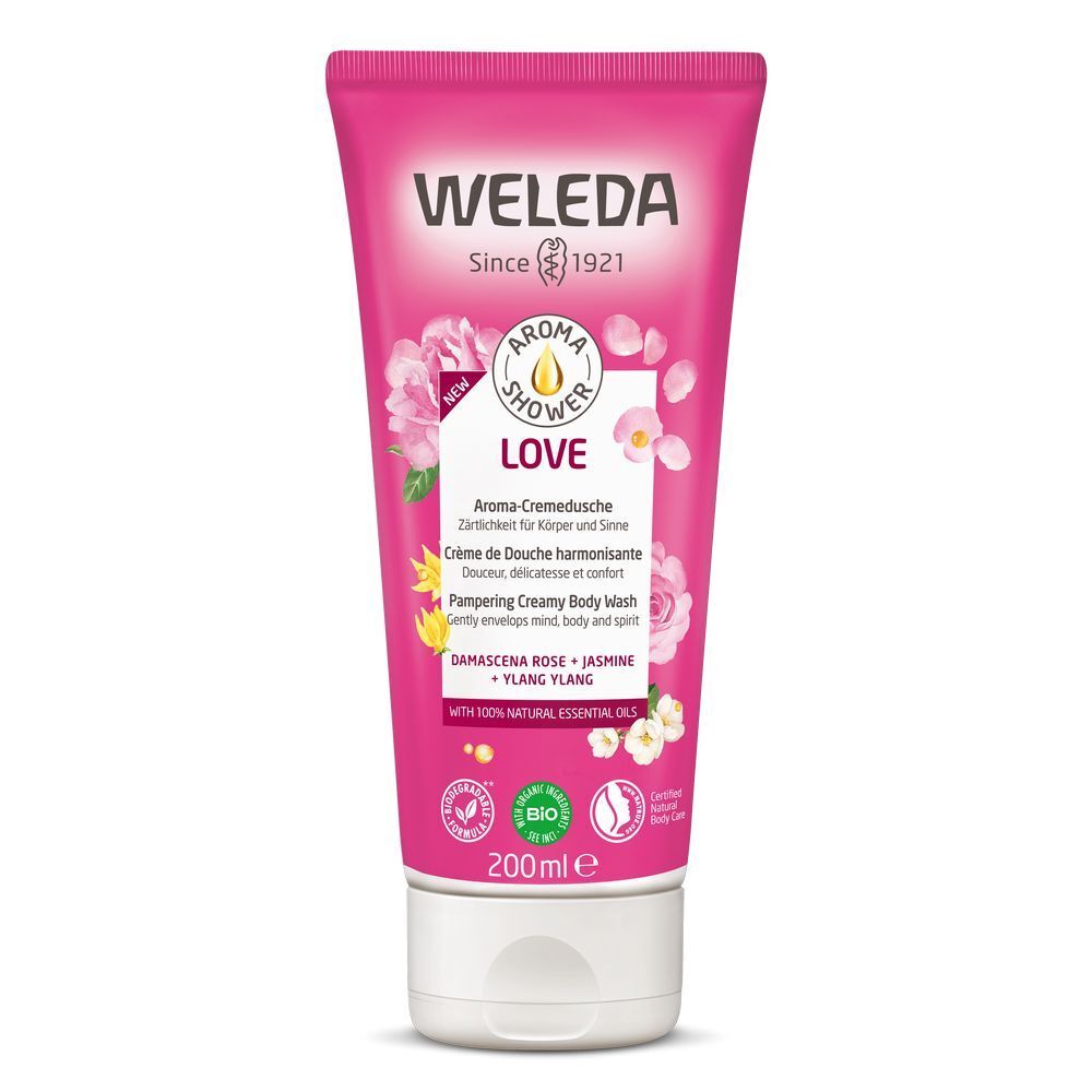 Roze tube met "WELEDA"-logo en "LOVE". Tekst: Aroma douchecrème, zachte bloemengeur. Bio-keurmerk.