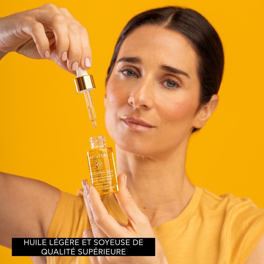 Flacon avec bouchon doré et pipette. Fond jaune.