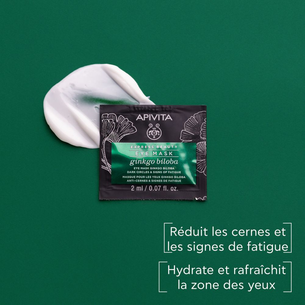 Masque pour les yeux sur fond vert. Texte : Réduit les cernes et la fatigue. Hydrate et rafraîchit.