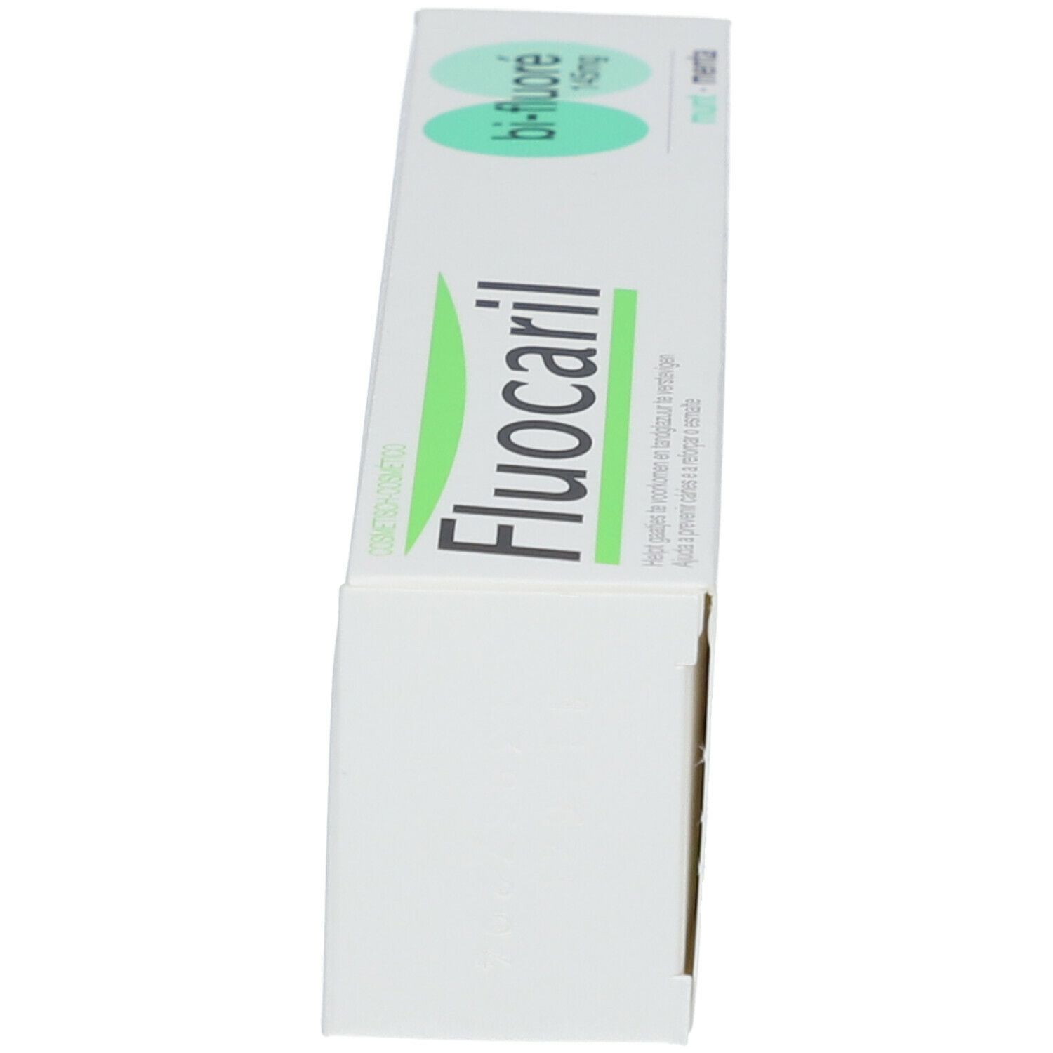 Zahnpasta-Schachtel. Weiß, grün. Aufschrift: Fluocaril, Bi-Fluoré 145mg. Seite mit Text und Logo.