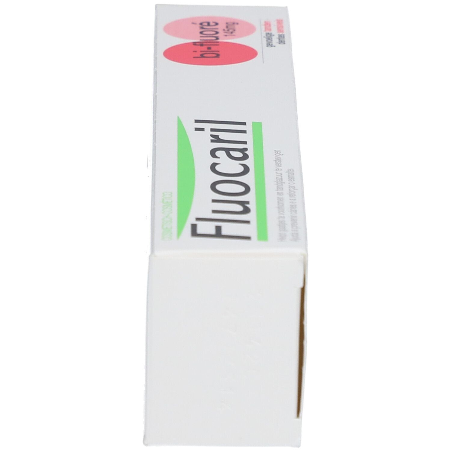 Tandpastadoos. Opschrift: Fluocaril, Bi-Fluoré 145mg, Dents sensibles. Witte doos met roze accenten.