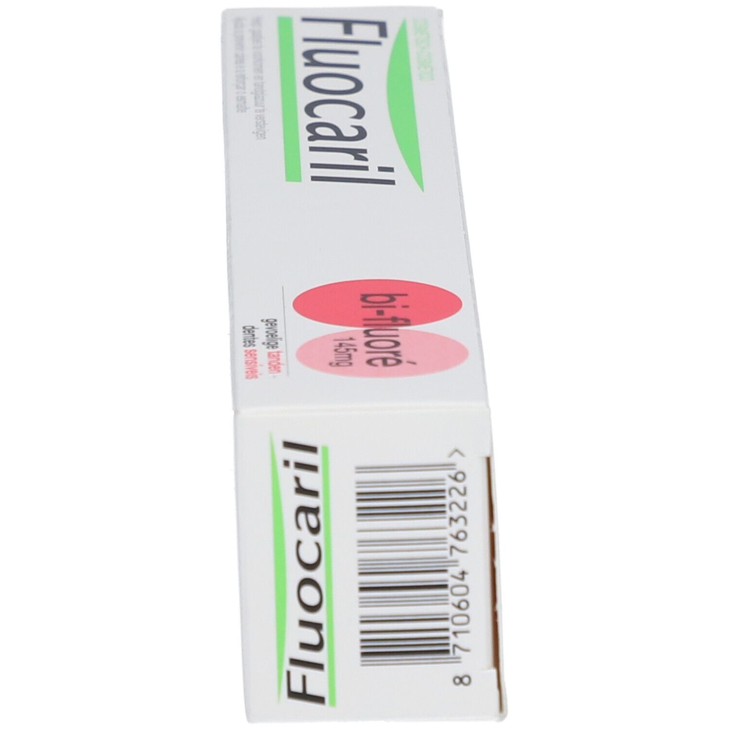Tandpastadoos. Opschrift: Fluocaril, Bi-Fluoré 145mg, Dents sensibles. Witte doos met roze accenten.