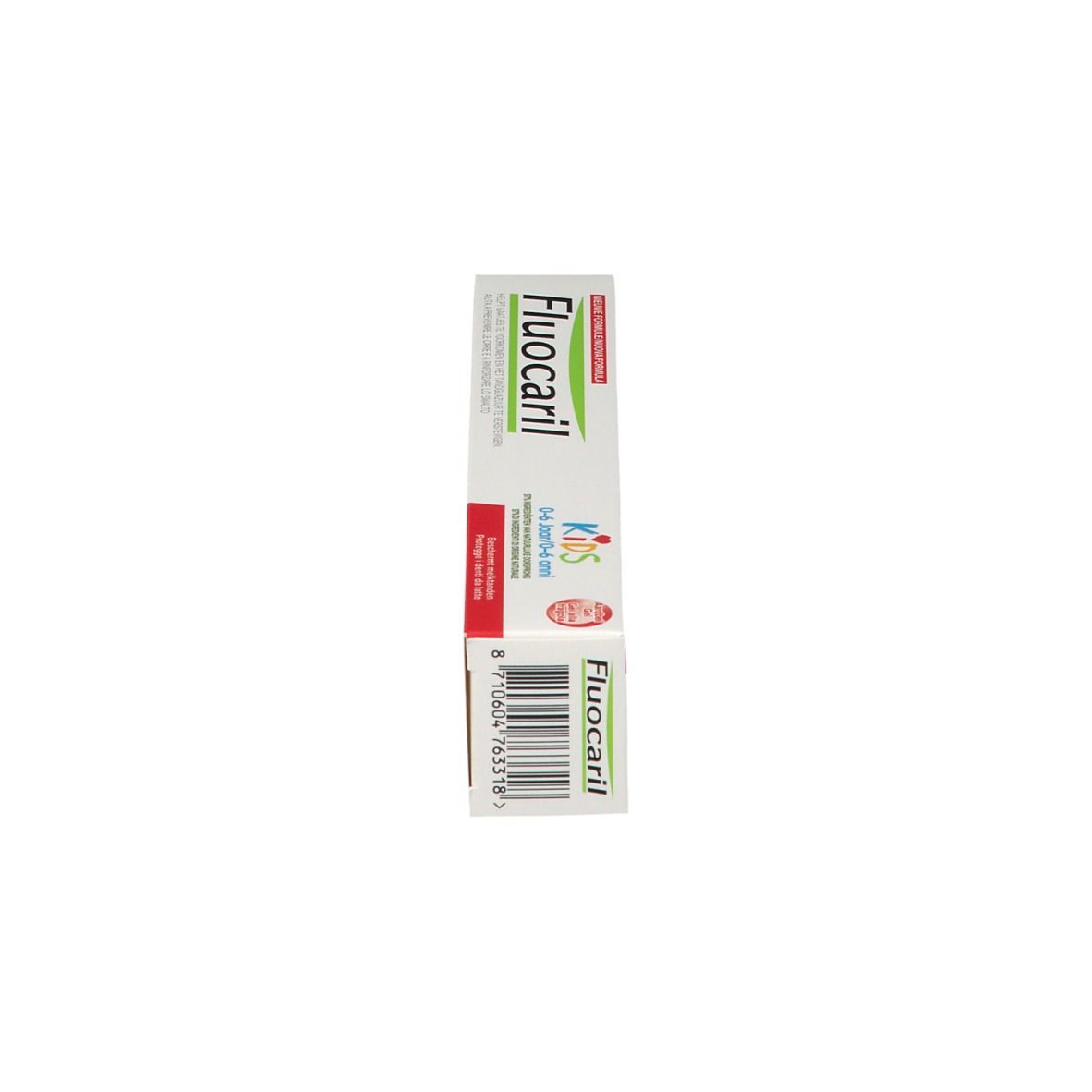 Boîte de dentifrice pour enfants. Blanc, avec texte rouge et vert. Inscription : Fluocaril Kids 0-6 ans.