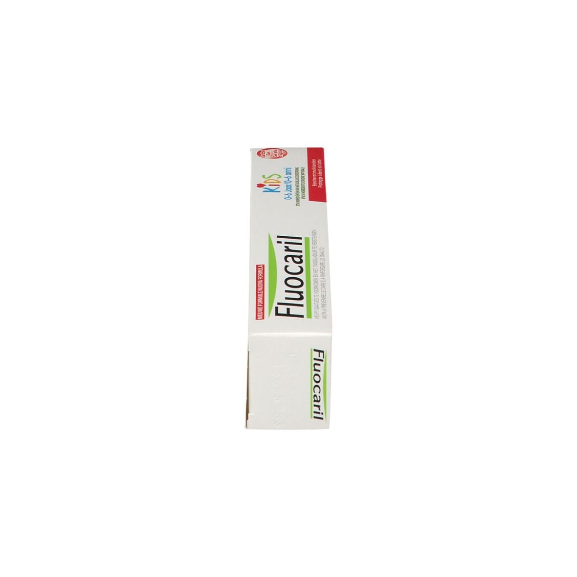 Boîte de dentifrice pour enfants. Blanc, avec texte rouge et vert. Inscription : Fluocaril Kids 0-6 ans.