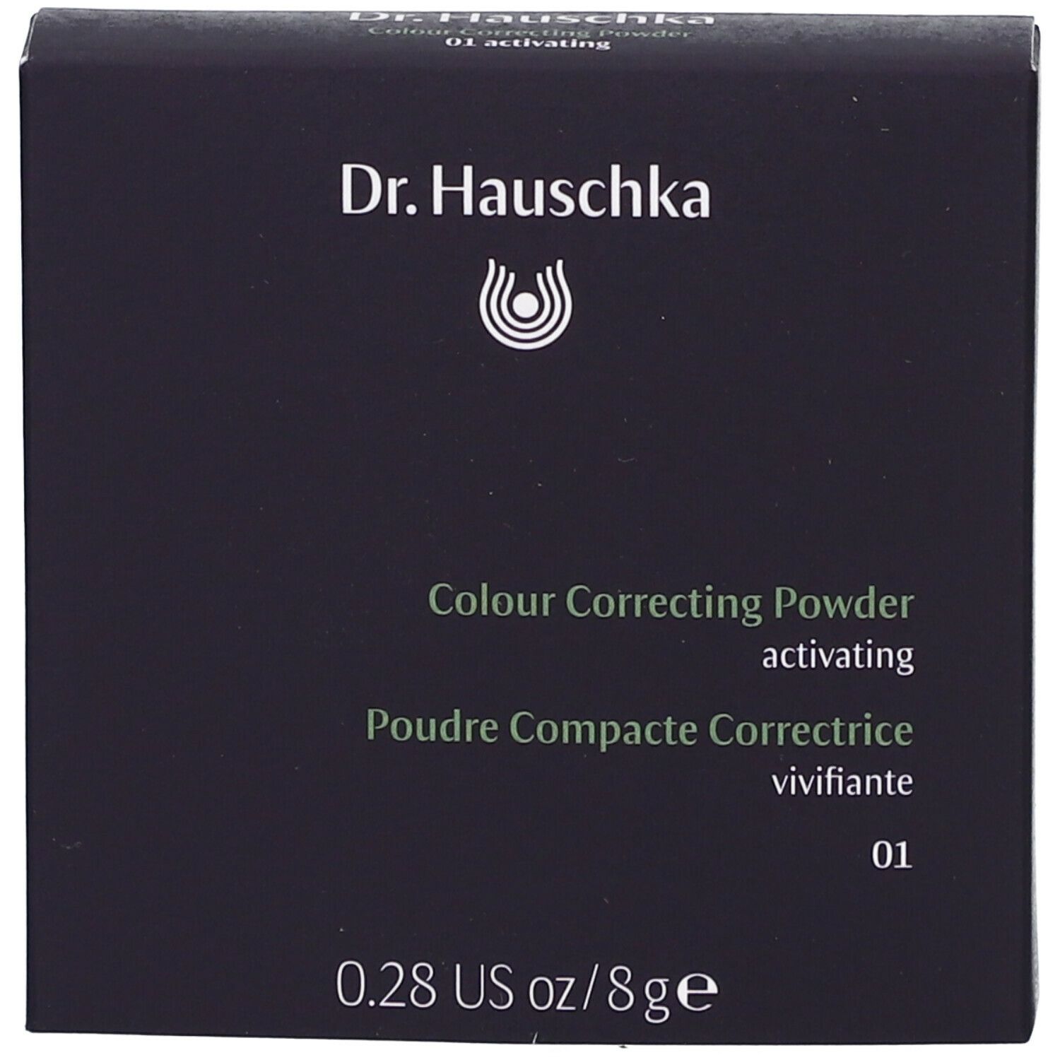 Emballage en carton noir. Nom du produit et marque Dr. Hauschka. Texte : Poudre Compacte Correctrice.
