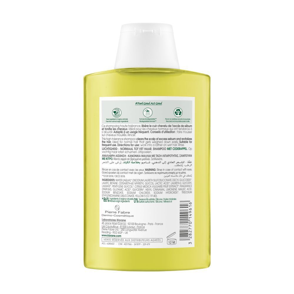 Achterkant van de Klorane shampoo fles. Tekstinformatie, ingrediënten, logo's. Gele vloeistof zichtbaar.