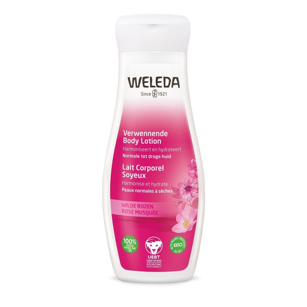 Weleda Body Lotion fles. Witte dop, roze etiket met tekst en logo. Certificeringen onderaan.