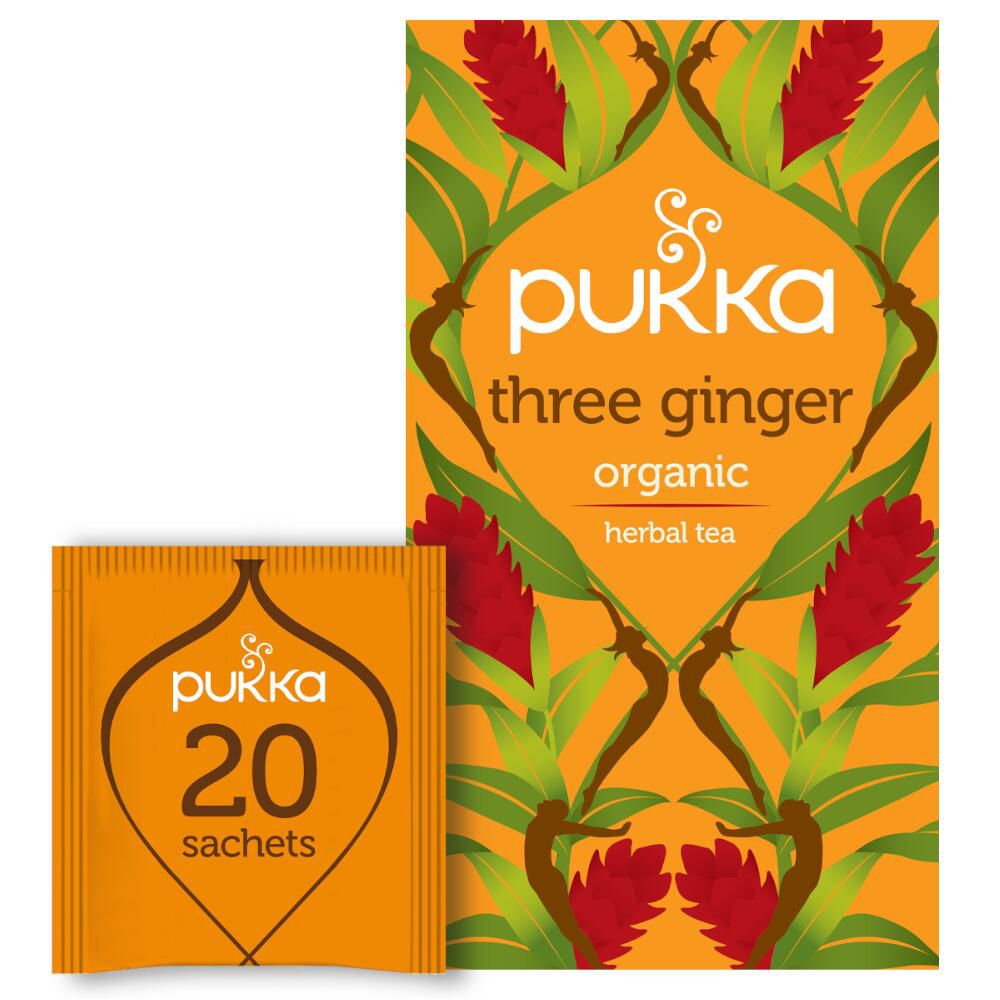Pukka Three Ginger thé. Emballage orange avec motif floral et informations sur le produit. Sachet de thé individuel à côté.