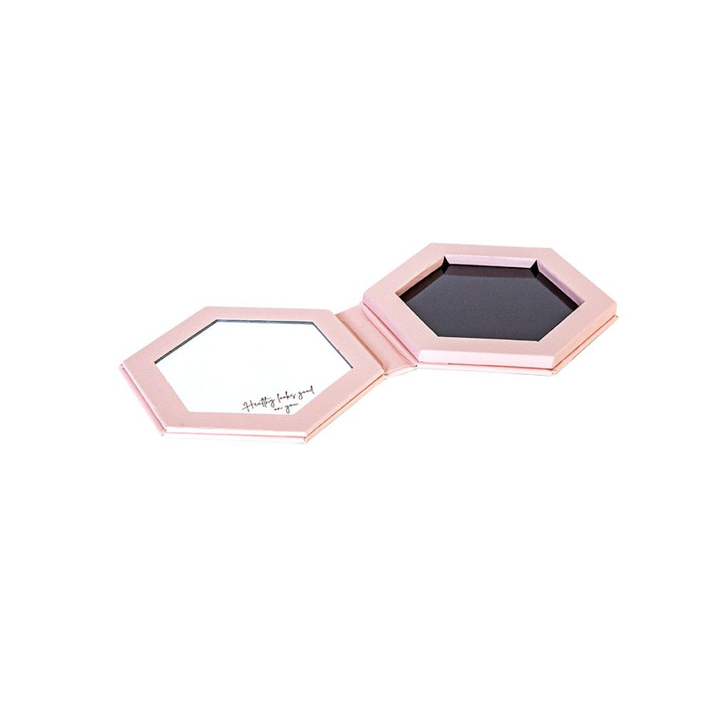 Open, roze make-up palette met spiegel en oogschaduw. Spiegel met tekst "Pretty baby, good for you".