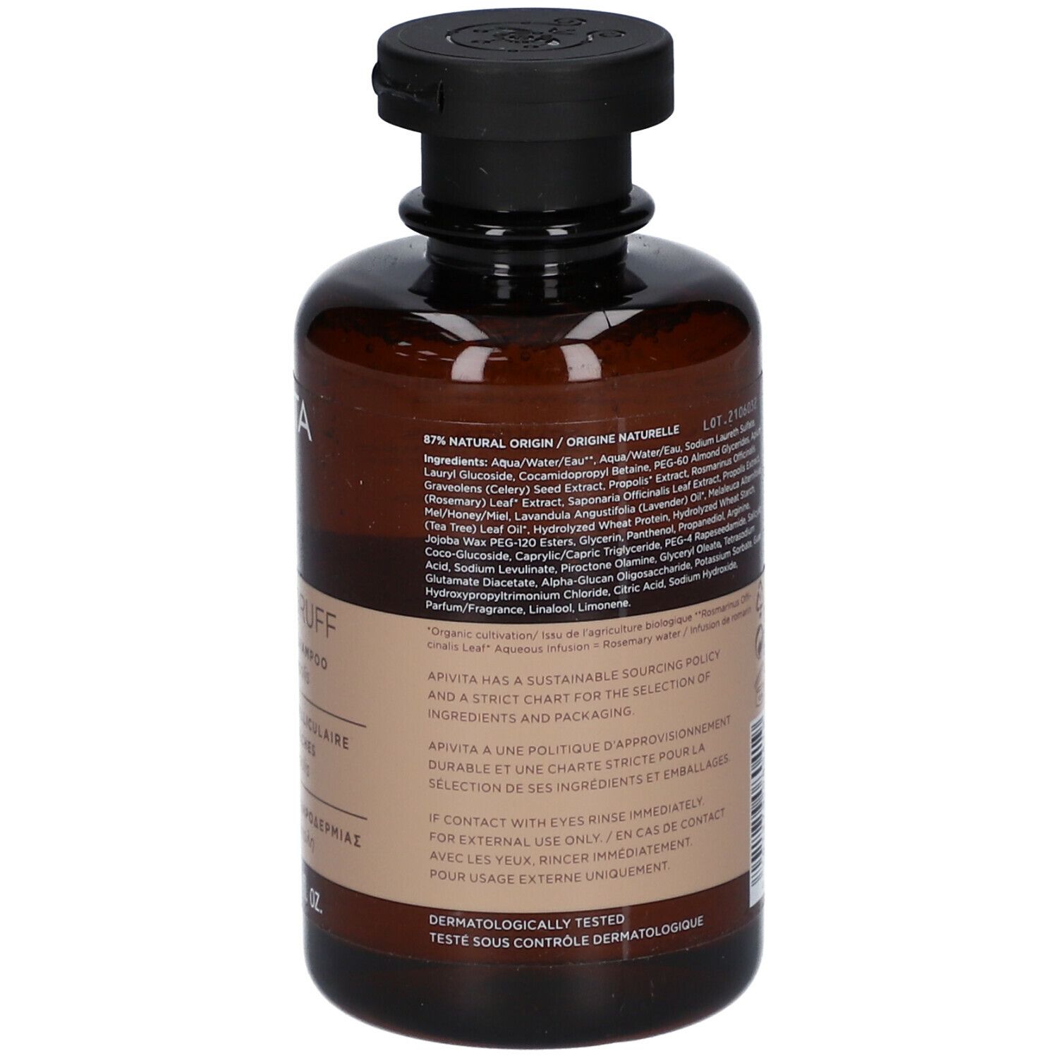 Achterkant van een bruine fles met zwarte dop. Meertalige tekst. Opschrift: DRY DANDRUFF Shampoo.