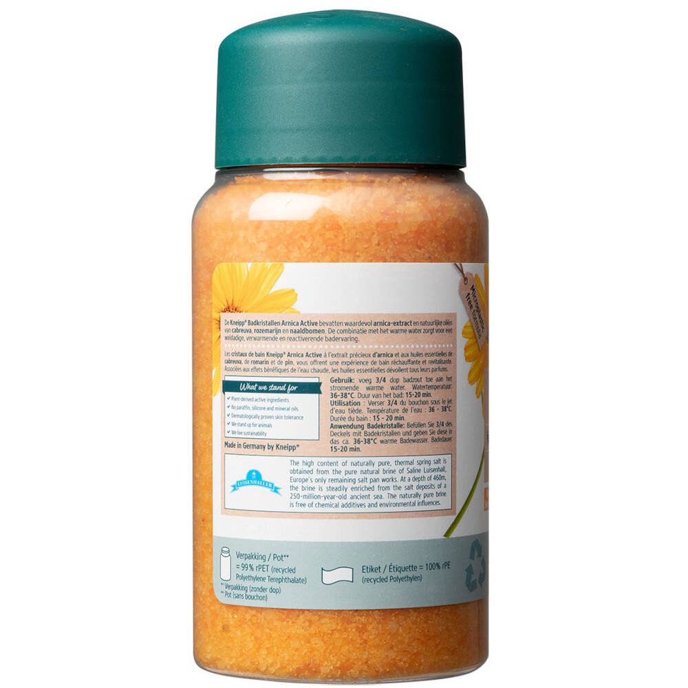 Dos d'un flacon transparent de cristaux de bain orange. Bouchon vert. Étiquette avec texte.