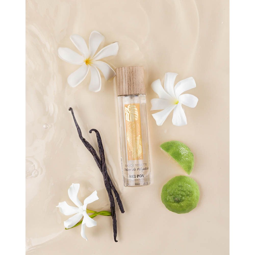 Flacon d'eau de toilette avec fleurs, gousses de vanille et citrons verts. Marque: Hei Poa.