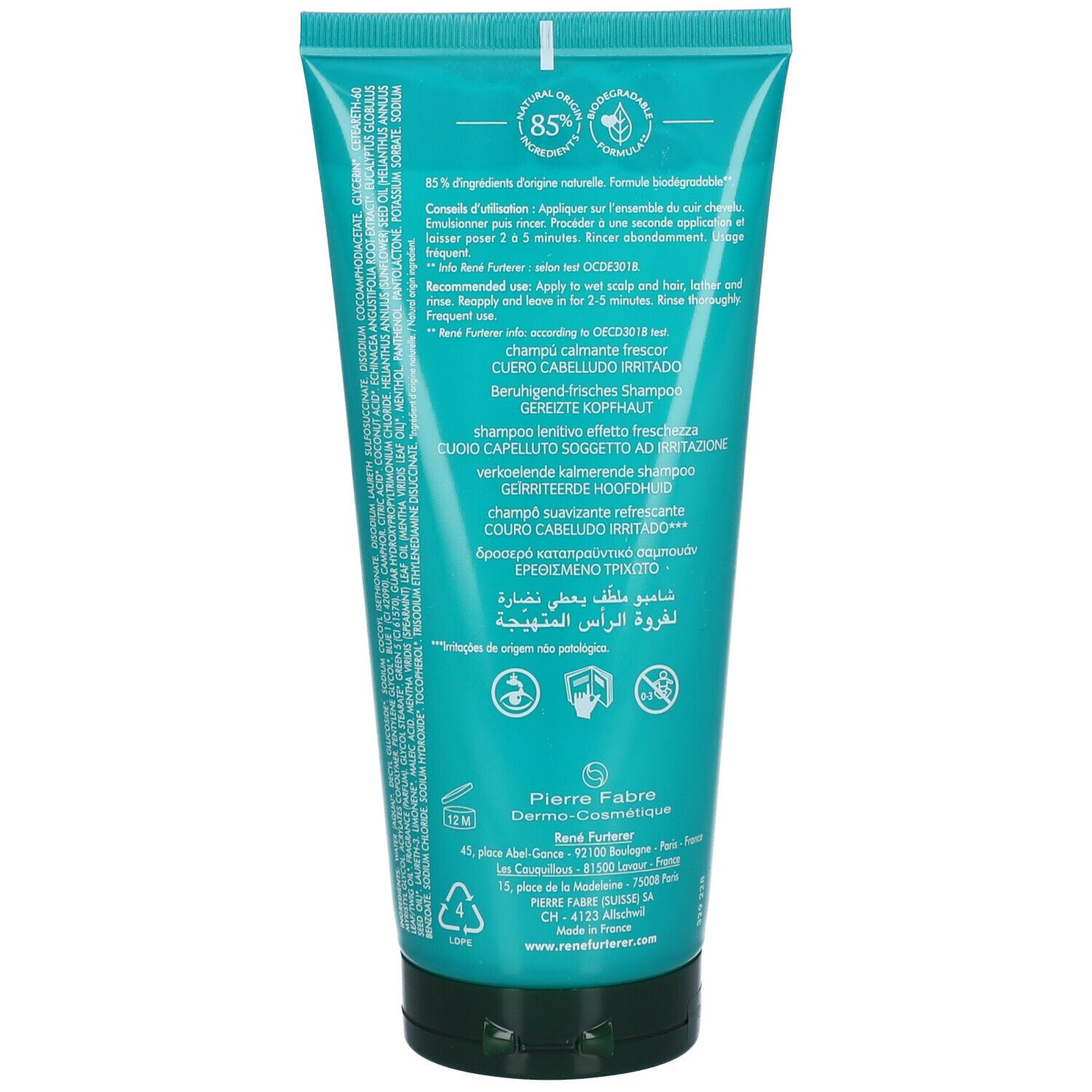 Achterkant van de turquoise shampoo tube. Tekst: 85% ingrediënten van natuurlijke oorsprong. Gebruiksaanwijzing in meerdere talen.